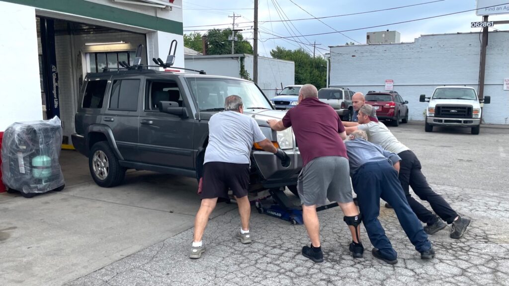 pushing car into garage